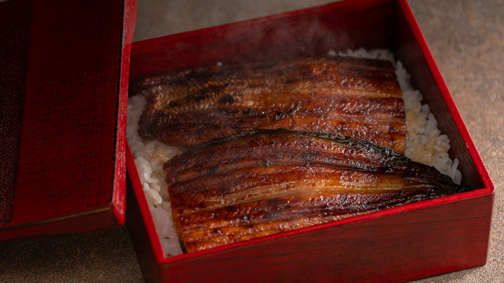 A lacquered unaju box filled with grilled eel over steamed rice