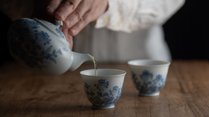 Pouring tea from a Japanese kyusu teapot into a cup