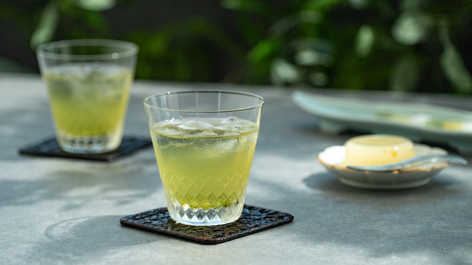 A glass of cold-brewed Japanese tea with ice on a summer table