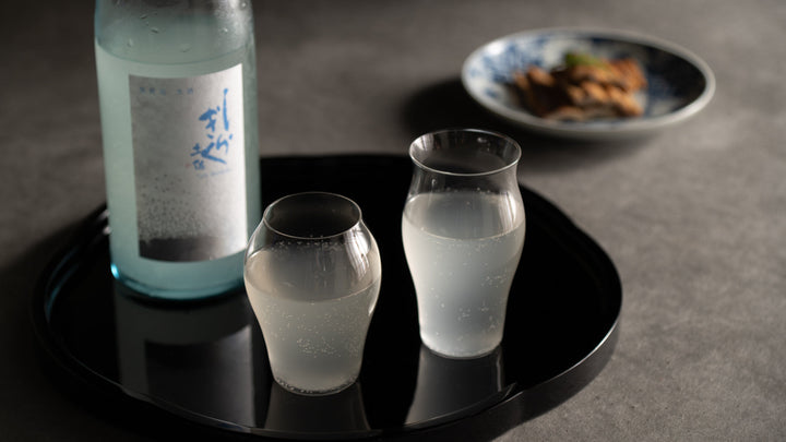 Chilled Japanese sake poured into a glass cup, capturing the refreshing character of natsuzake, summer sake.