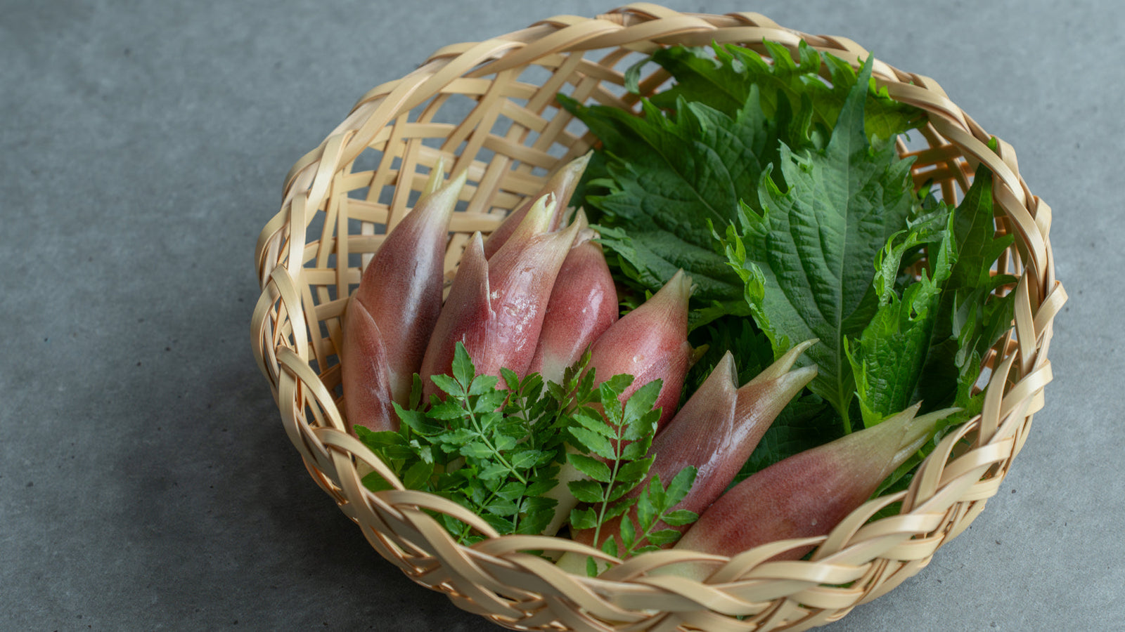 Fresh Japanese culinary herbs such as shiso and myoga arranged together