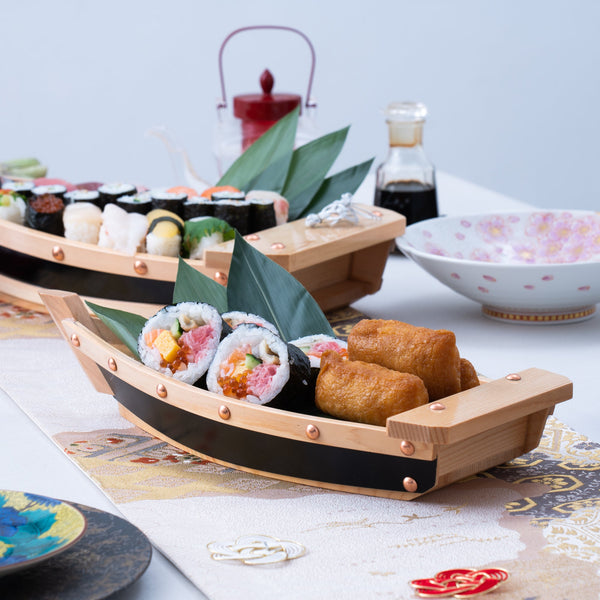 Japanese sushi set. Various types of roles on plate over stone
